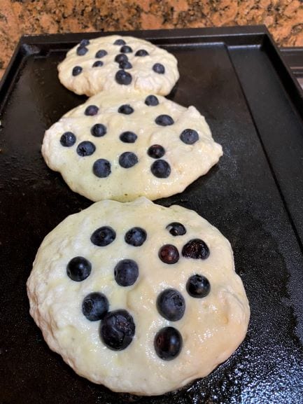 Blueberry pancakes being cooked
