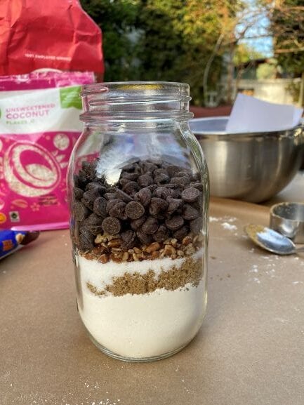 Chocolate chips and other cookie ingredients in a jar